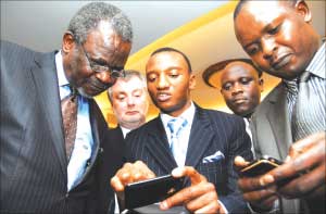 SEACOM’s John Mathwasa (centre) explains the network operation to Awori (left) and his state minister Nsambu Alintuma (right) -Image Scource: New Vision